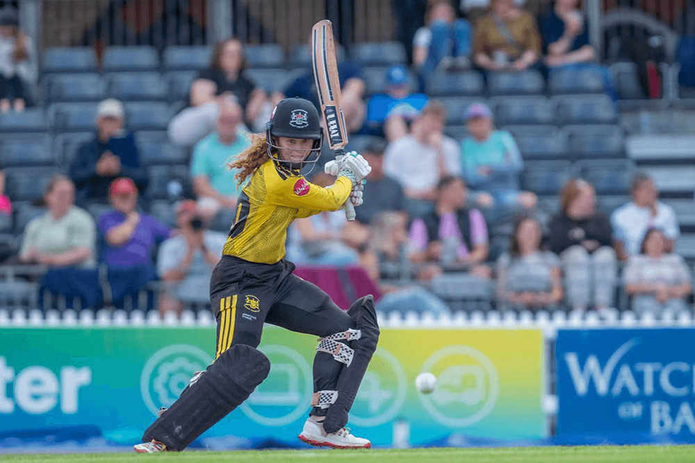A county age group player batting in a match